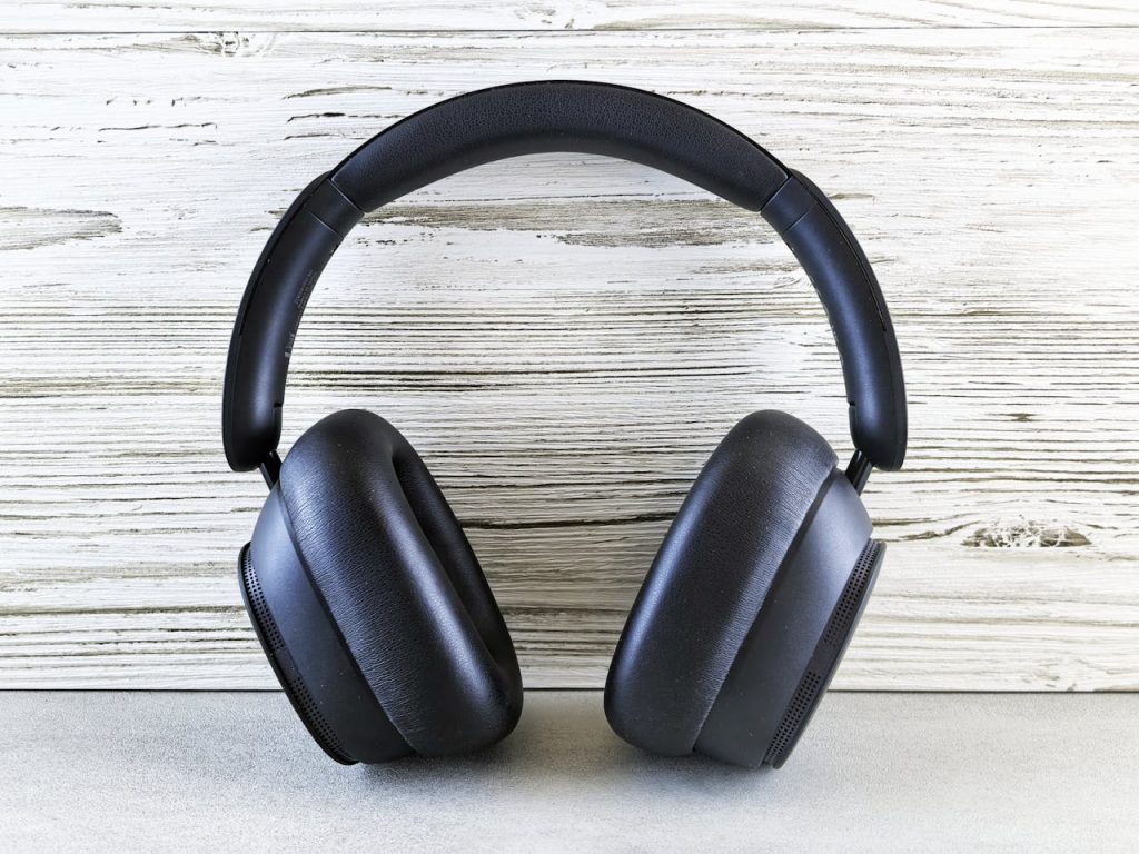 Stylish black over-ear headphones against a wooden backdrop, perfect for music lovers.